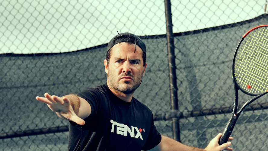 Tennis player, Marty Dunn, playing on a court